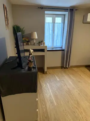 a living room with a desk and a window at Appartement détente dans les corbières in Conilhac-Corbières