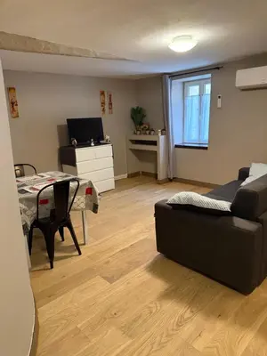 a living room with a couch and a table at Appartement détente dans les corbières in Conilhac-Corbières