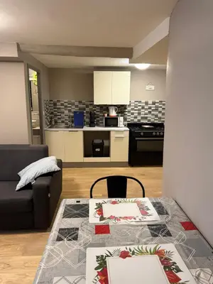 a living room with a table and a kitchen at Appartement détente dans les corbières in Conilhac-Corbières