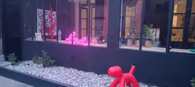 a red figurine standing in front of a window at Day rental for Family Reunion, Anniv in Mazères