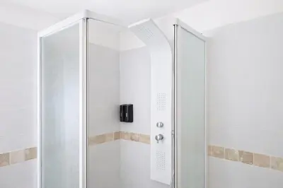 a shower with a glass door in a bathroom at La parenthèse Carcassonnaise - 4 voyageurs - Terrasse - Proche cité médiévale in Carcassonne