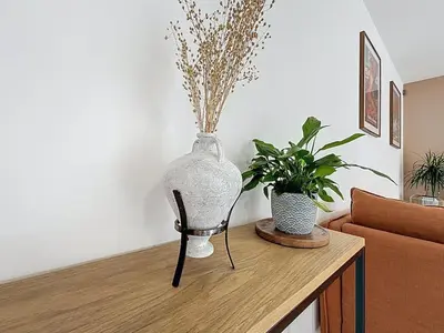 a vase sitting on top of a table with two plants at La Caminade - Maison Neuve - Climatisation et Wifi in Saint-André-de-Roquelongue