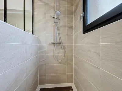a shower with a shower head in a bathroom at La Caminade - Maison Neuve - Climatisation et Wifi in Saint-André-de-Roquelongue