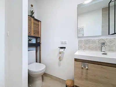 a bathroom with a toilet and a sink at La Caminade - Maison Neuve - Climatisation et Wifi in Saint-André-de-Roquelongue