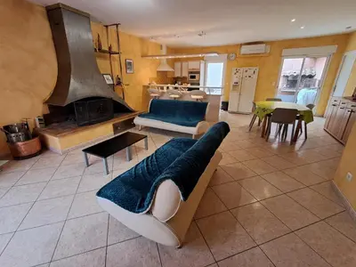 a living room with a couch and a fireplace at Villa Pierrot in Portel-des-Corbières