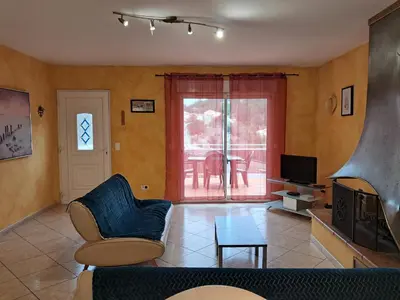 a living room with a couch and a tv at Villa Pierrot in Portel-des-Corbières