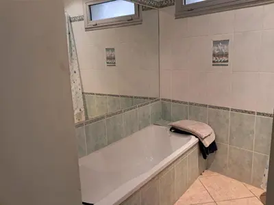 a bathroom with a bath tub and a towel at Villa Pierrot in Portel-des-Corbières