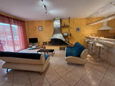 a living room with two couches and a stove at Villa Pierrot in Portel-des-Corbières