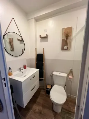 a bathroom with a white toilet and a sink at Charmant Studio Narbonnais in La Celle-sous-Gouzon