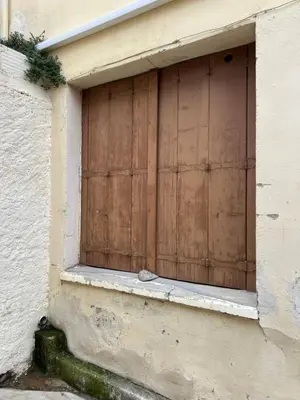 a wooden door on the side of a building at Charmant Studio Narbonnais in La Celle-sous-Gouzon