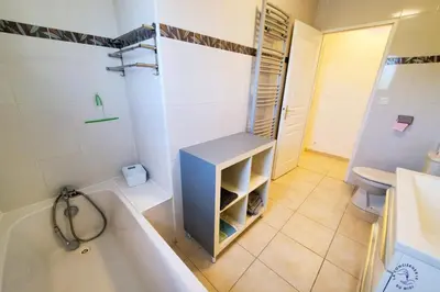 a bathroom with a tub and a sink and a toilet at La Saline maison familiale avec jardin in Lapalme