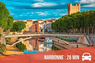 a bridge over a river in a city at La Saline maison familiale avec jardin in Lapalme