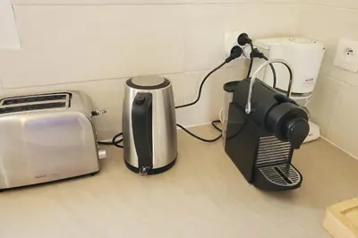 a coffee maker and a toaster on a kitchen counter at La Saline maison familiale avec jardin in Lapalme