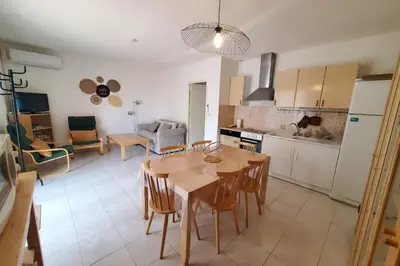 a kitchen and dining room with a table and chairs at Le Salvador paisible maisonette pour 4 in Sigean