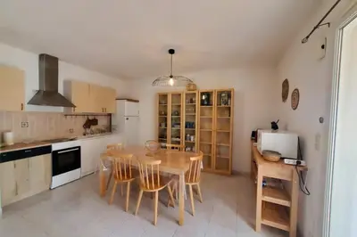 a kitchen with a table and chairs in a room at Le Salvador paisible maisonette pour 4 in Sigean