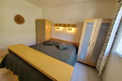 a small bedroom with a bed and a ladder at Le Salvador paisible maisonette pour 4 in Sigean
