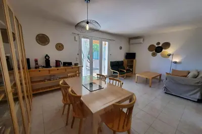 a living room with a wooden table and chairs at Le Salvador paisible maisonette pour 4 in Sigean