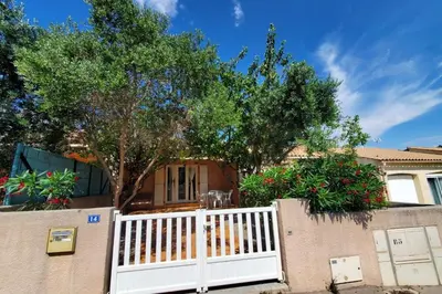 a house with a white fence and a tree at Le Salvador paisible maisonette pour 4 in Sigean