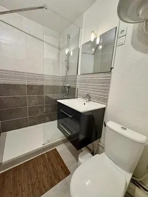 a bathroom with a toilet and a sink and a shower at Studio à deux pas du port avec piscine in Gruissan