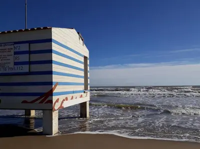 a sign on the beach next to the ocean at Studio à deux pas du port avec piscine in Gruissan