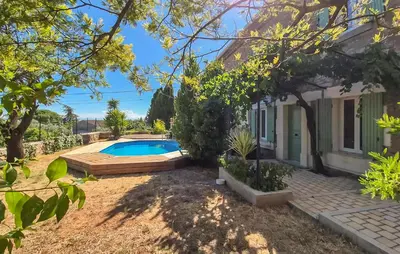 a backyard with a swimming pool and a house at Gorgeous Home In Villespassans in Villespassans