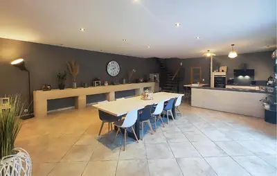a large room with a table and chairs and a kitchen at Stunning Home In Puisserguier in Puisserguier