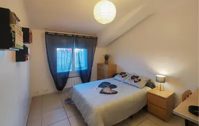 a bedroom with a bed and a window at Stunning Home In Puisserguier in Puisserguier