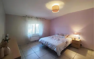 a small bedroom with a bed and a window at Stunning Home In Puisserguier in Puisserguier