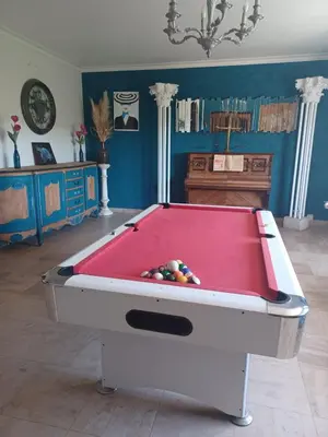 a pool table in a living room with at Maison Sol Air in Montazels