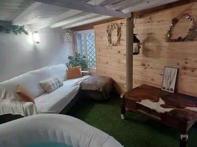 a living room with a white couch and a table at Maison Sol Air in Montazels