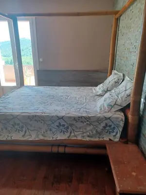 a bedroom with a bed with a wooden frame at Maison Sol Air in Montazels