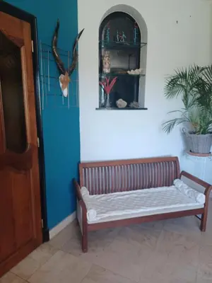 a wooden bench in a room with a blue wall at Maison Sol Air in Montazels