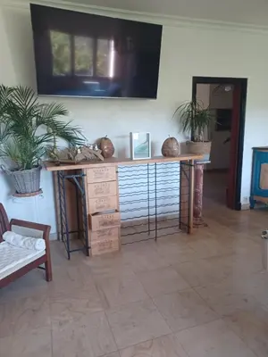 a room with a table with boxes and a tv at Maison Sol Air in Montazels