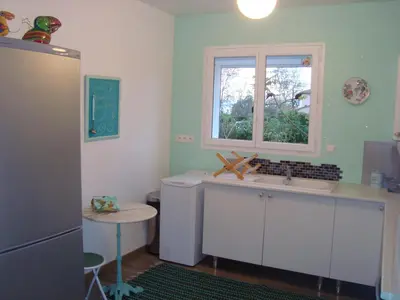 a kitchen with a sink and a window at Maison dans un écrin de verdure in Sorèze