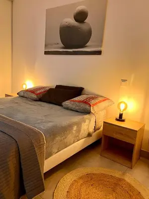 a bedroom with a bed with a sculpture on the wall at Loft jacuzzi à 8 min des Grands Buffets et du centre-ville in Narbonne