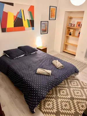 a bedroom with a bed with two pillows on it at Loft jacuzzi à 8 min des Grands Buffets et du centre-ville in Narbonne