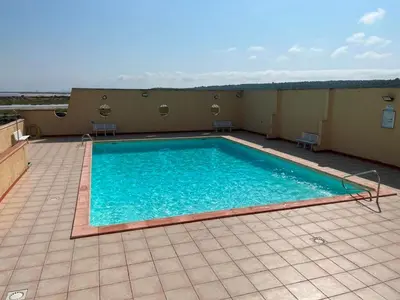 a swimming pool on the roof of a building at Gruissan : T2 Climat. et Parking Proche Village - FR-1-796-96 in Gruissan