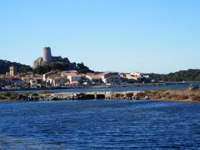 a view of a river with a town in the background at Gruissan : T2 Climat. et Parking Proche Village - FR-1-796-96 in Gruissan