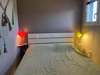 a bedroom with a bed with two lamps on it at Gruissan : T2 Climat. et Parking Proche Village - FR-1-796-96 in Gruissan