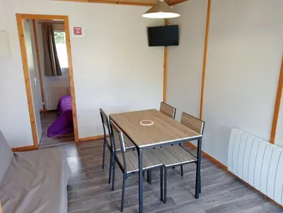a bedroom with two beds with purple sheets and a teddy bear on them at Camping 3 étoiles - Piscine - ccbeed0 in Mazères