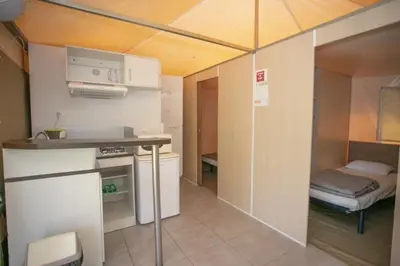 two beds in a room with purple blankets at Camping 3 étoiles - Piscine - ccbeed0 in Mazères