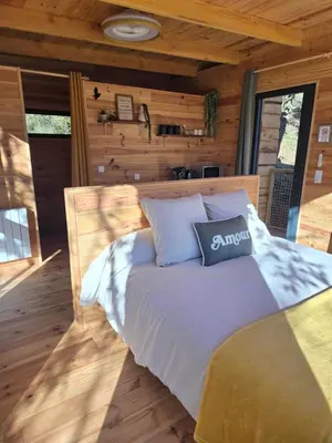 a bedroom with a bed in a log cabin at La parenthèse in Ansignan
