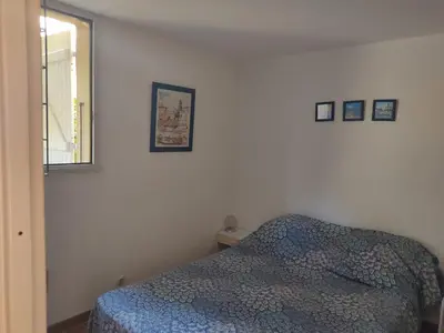 a bedroom with a bed and pictures on the wall at Gruissan - Villa 6 Pers - Terrasses - Secteur Calme - FR-1-796-102 in Gruissan