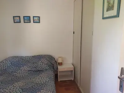 a small bedroom with a bed and a night stand at Gruissan - Villa 6 Pers - Terrasses - Secteur Calme - FR-1-796-102 in Gruissan