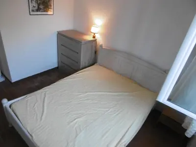 a small bed in a room with a lamp on it at Villa T4 8 pers proche plage Grazel, parking privé et terrasse - FR-1-796-98 in Gruissan
