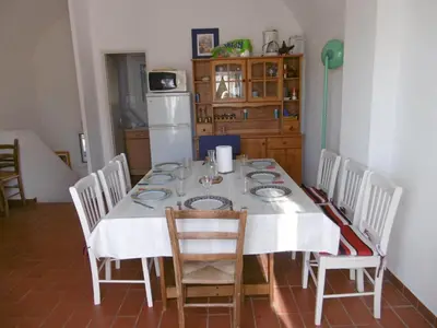a dining room table with a white table cloth and chairs at Villa T4 8 pers proche plage Grazel, parking privé et terrasse - FR-1-796-98 in Gruissan