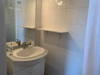 a white bathroom with a sink and a mirror at Studio Coquet 2/3 Pers au Cœur de Gruissan - FR-1-796-99 in Gruissan