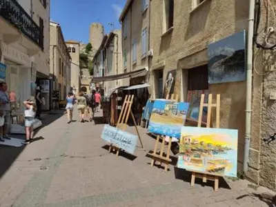 a group of people walking down a street with paintings at Studio Coquet 2/3 Pers au Cœur de Gruissan - FR-1-796-99 in Gruissan