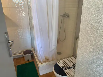 a small bathroom with a shower with a shower curtain at Studio Coquet 2/3 Pers au Cœur de Gruissan - FR-1-796-99 in Gruissan