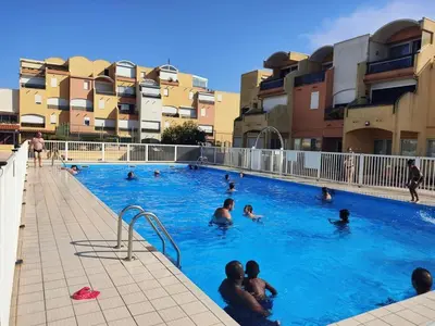a group of people swimming in a swimming pool at Studio Coquet 2/3 Pers au Cœur de Gruissan - FR-1-796-99 in Gruissan